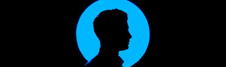 Background image for Designing Devices for Human Needs. This image shows a photo-realistic silhouette of an adult male’s bust in profile in front of a large, light blue dot.